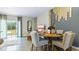 Dining room with modern decor, accent wall, and sliding glass door to a green backyard at 4419 Rachel Falls Dr, Tampa, FL 33610
