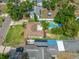 An aerial view showing a community pool with beautiful landscaping and mature trees at 4721 W Lawn Ave, Tampa, FL 33611