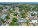 A high angle view showing a neighborhood with mature trees and a body of water at 4721 W Lawn Ave, Tampa, FL 33611