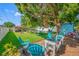 Serene backyard featuring lush greenery, mature trees, and comfortable seating, perfect for relaxing and entertaining at 4721 W Lawn Ave, Tampa, FL 33611