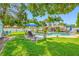 Backyard with a sparkling pool, lush landscaping, and comfortable lounge chairs, perfect for outdoor living at 4721 W Lawn Ave, Tampa, FL 33611