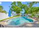 Tranquil backyard showcasing a sparkling pool, paved patio, white vinyl fence, and well-maintained green lawn at 4721 W Lawn Ave, Tampa, FL 33611