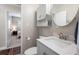 Bright bathroom with a quartz countertop and white cabinets; a doorway leads to the bedroom at 4721 W Lawn Ave, Tampa, FL 33611