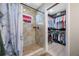 Updated bathroom featuring a walk-in shower and walk-in closet with ample storage space at 4721 W Lawn Ave, Tampa, FL 33611