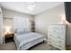 This is a bedroom featuring a ceiling fan, shuttered window, and furniture at 4721 W Lawn Ave, Tampa, FL 33611