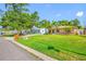 Charming single-story home with a well-manicured lawn and tropical landscaping at 4721 W Lawn Ave, Tampa, FL 33611