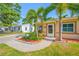 Well-maintained front yard with a charming walkway, vibrant foliage, and lush green lawn at 4721 W Lawn Ave, Tampa, FL 33611