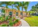 Beautifully landscaped front yard with lush plantings and palm trees at 4721 W Lawn Ave, Tampa, FL 33611