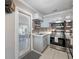 Updated kitchen features stainless appliances, mosaic backsplash, and door to the backyard at 4721 W Lawn Ave, Tampa, FL 33611