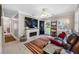 Inviting living room with a modern fireplace, stylish decor, and natural light, perfect for relaxing at 4721 W Lawn Ave, Tampa, FL 33611