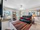 Cozy living room featuring a comfortable leather sofa, bright windows, and stylish decor, ideal for relaxing at 4721 W Lawn Ave, Tampa, FL 33611