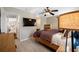 Cozy main bedroom with ceiling fan and matching wood dresser and nightstands at 4721 W Lawn Ave, Tampa, FL 33611