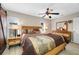 Bright main bedroom with ceiling fan, lamps, and matching dresser and nightstands at 4721 W Lawn Ave, Tampa, FL 33611