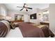 This comfortable main bedroom features a ceiling fan and a neutral color scheme at 4721 W Lawn Ave, Tampa, FL 33611