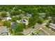 Neighborhood view with mature trees surrounding houses with solar panels on roof at 509 N Walker St, Plant City, FL 33563
