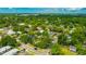 An aerial view shows a neighborhood with mature trees surrounding well-maintained houses and neatly kept lawns at 509 N Walker St, Plant City, FL 33563