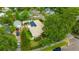 An aerial view of home with solar panels, a metal roof, and mature landscaping at 509 N Walker St, Plant City, FL 33563