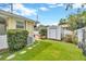 Well-maintained backyard features a storage shed, lush lawn, and a stepping stone path at 509 N Walker St, Plant City, FL 33563