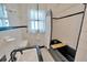 Classic bathroom featuring black and white tiles, shower-tub combo and window with natural light at 509 N Walker St, Plant City, FL 33563