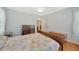 Bright bedroom featuring hardwood floors, ceiling fan, chest of drawers, and windows with natural light at 509 N Walker St, Plant City, FL 33563