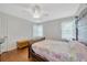 Cozy bedroom featuring hardwood floors, ceiling fan, and windows with natural light at 509 N Walker St, Plant City, FL 33563