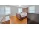 Bright bedroom featuring hardwood floors, ceiling fan, and windows with natural light at 509 N Walker St, Plant City, FL 33563