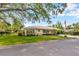 Charming single-story home featuring a metal roof, well-manicured lawn and mature landscaping, including a large shade tree at 509 N Walker St, Plant City, FL 33563