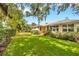 Well-maintained house with lush green lawn and mature landscaping; the exterior of the home is a welcoming yellow color at 509 N Walker St, Plant City, FL 33563