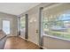 Light-filled foyer features wood-look flooring, a stylish front door, and an additional door, offering a warm welcome at 509 N Walker St, Plant City, FL 33563