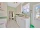 Well-equipped laundry room featuring a utility sink, washer, dryer, and an exterior door at 509 N Walker St, Plant City, FL 33563