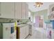 Functional laundry area featuring a utility sink, washer, dryer hookups, and ample storage at 509 N Walker St, Plant City, FL 33563