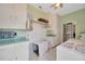 Spacious laundry room with ample storage, green accents, and room for utility and chores at 509 N Walker St, Plant City, FL 33563
