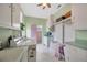 Bright laundry room with ample counter space, mint green accents, and a utility sink at 509 N Walker St, Plant City, FL 33563