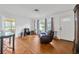 Cozy living room featuring a leather recliner, hardwood floors, and lots of natural light at 509 N Walker St, Plant City, FL 33563