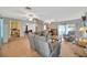 Expansive living room featuring wood-look floors, a cozy fireplace, and an open layout leading to the dining area and kitchen at 509 N Walker St, Plant City, FL 33563