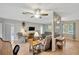 Open-concept living room with wood-look floors, neutral paint, and multiple seating areas; a perfect space for entertaining at 509 N Walker St, Plant City, FL 33563