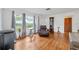 Bright living room with hardwood floors, large windows, and a comfortable leather recliner at 509 N Walker St, Plant City, FL 33563