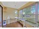 Bright sunroom bathed in natural light with an adjustable desk and tiled floors at 509 N Walker St, Plant City, FL 33563