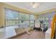 Bright sunroom bathed in natural light with a modern adjustable desk and chair at 509 N Walker St, Plant City, FL 33563