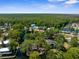 Beautiful aerial view capturing a peaceful waterfront community surrounded by a dense, vibrant forest and scenic waterways at 5421 Gay St, Weeki Wachee, FL 34607