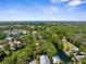 Expansive aerial view showcasing a charming coastal community with canals winding through lush, tree-lined neighborhoods at 5421 Gay St, Weeki Wachee, FL 34607
