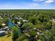 Scenic aerial shot highlighting waterfront properties and serene canal living, set against a backdrop of mature trees at 5421 Gay St, Weeki Wachee, FL 34607