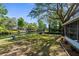 Waterfront backyard featuring a well-manicured lawn, mature trees, and scenic canal views, perfect for outdoor living at 5421 Gay St, Weeki Wachee, FL 34607