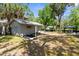 A well-kept backyard with a gazebo, lush trees, and a small outbuilding, perfect for outdoor relaxation at 5421 Gay St, Weeki Wachee, FL 34607