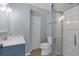 The renovated bathroom features a modern vanity and a glass-enclosed shower for a sleek and updated feel at 5421 Gay St, Weeki Wachee, FL 34607