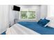 Bedroom with a window overlooking the backyard and modern furnishings at 5421 Gay St, Weeki Wachee, FL 34607