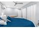 Bright bedroom with a ceiling fan, two windows with white curtains, and clean lines at 5421 Gay St, Weeki Wachee, FL 34607