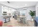 Sunlit dining area blends seamlessly with the kitchen, complete with dining table and chairs next to a breakfast bar at 5421 Gay St, Weeki Wachee, FL 34607