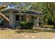Charming home with a welcoming front porch, lush landscaping, and an American flag at 5421 Gay St, Weeki Wachee, FL 34607