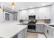 Beautifully updated kitchen with new cabinetry, countertops, stainless steel appliances and a view of the living space at 5421 Gay St, Weeki Wachee, FL 34607